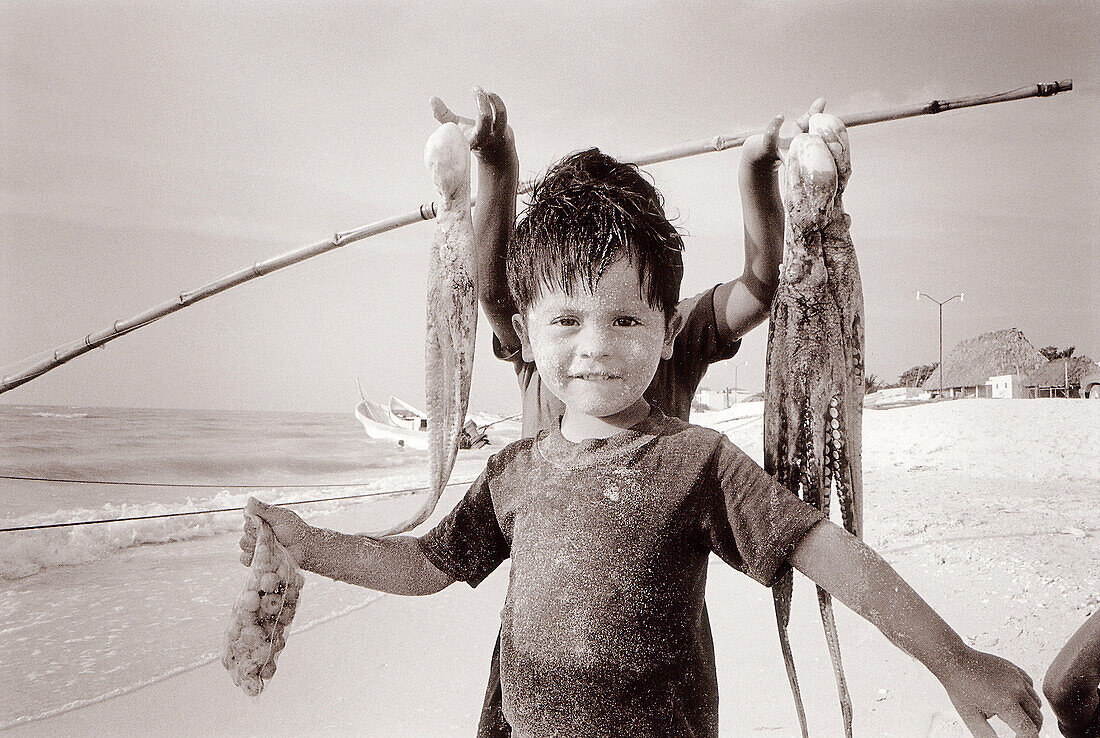 Children with octopuses. Celestun. Yucatan. Mexico