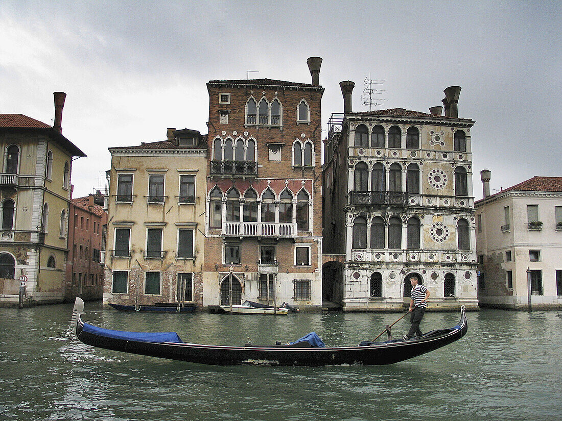 Gondolero in front of Dario palace. Grand Canal. Venice. Italy