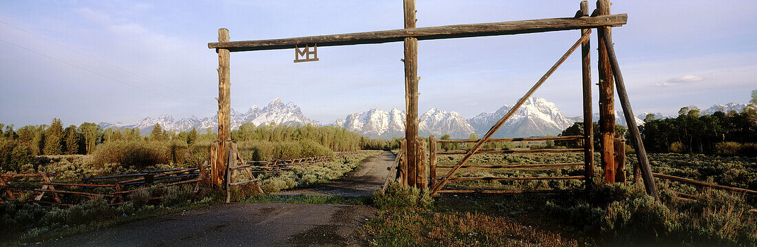 Ranch entrance road and gate, Teton mountain range, Grand Teton National Park. Teton County, Wyoming, USA