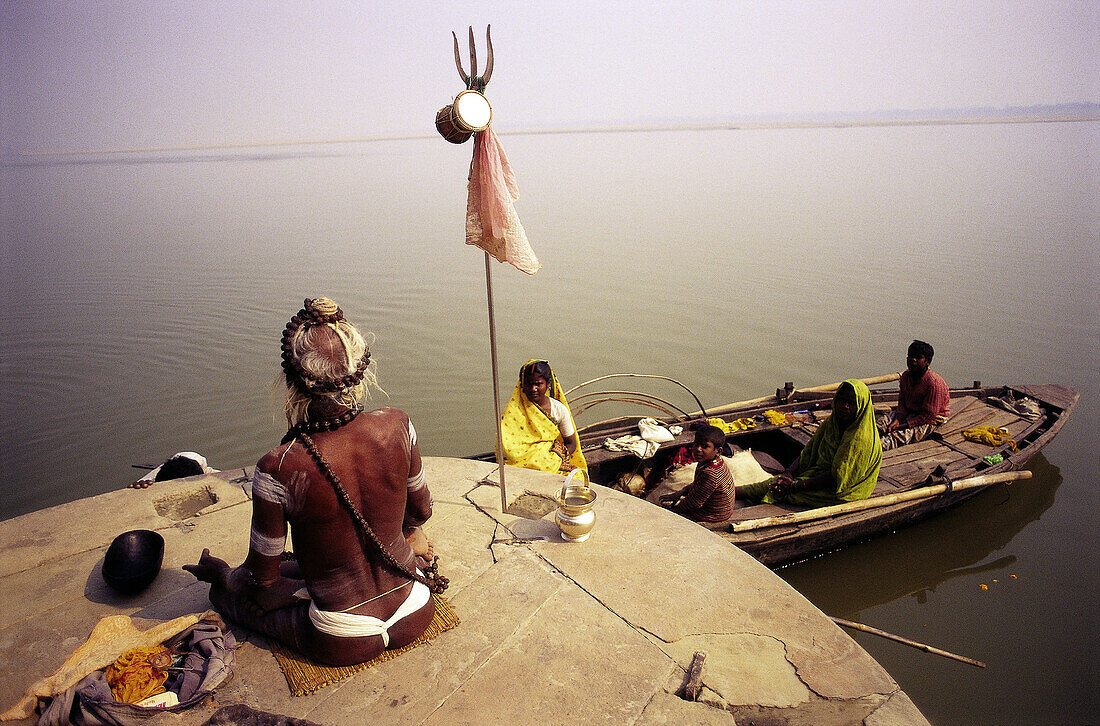 Hindu priest meditates by the River Ganges. Varanasi. India