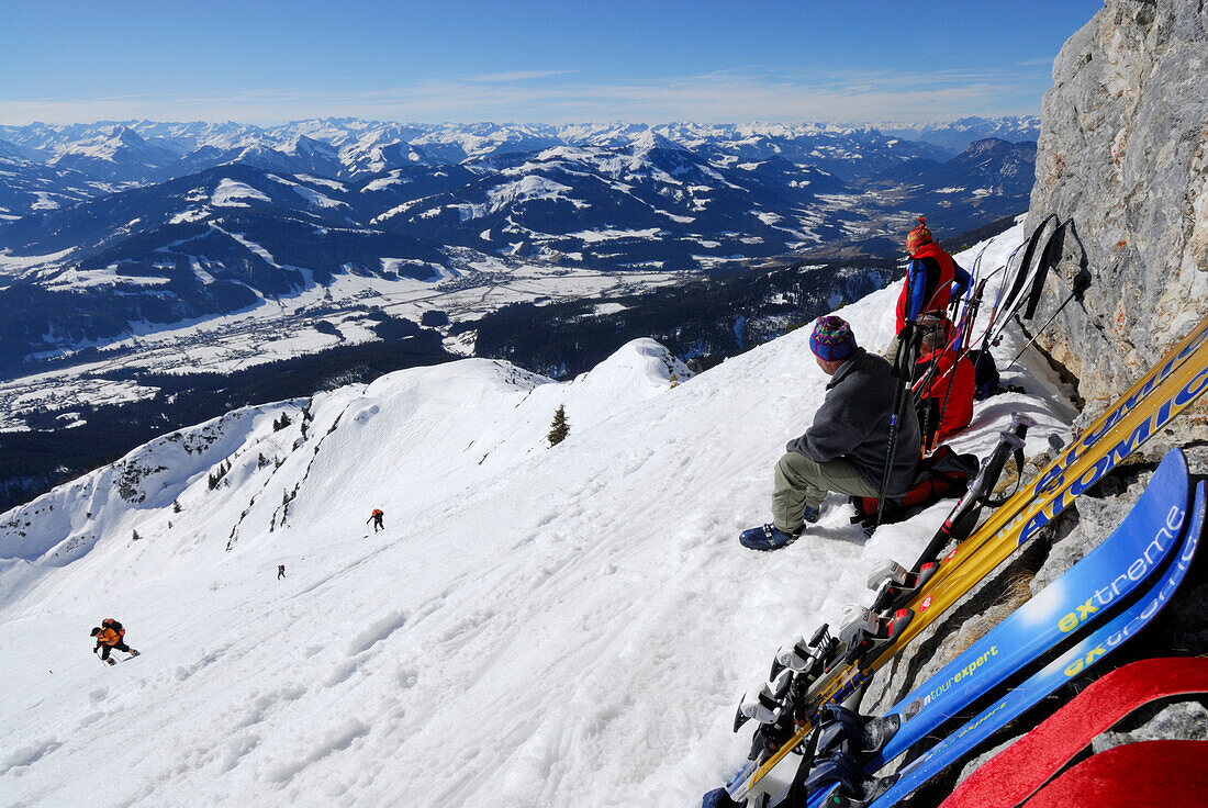 backcountry skiers ascending Herrenstein with view to Hohe Tauern and Zillertal range, Wilder Kaiser range, Kaisergebirge, Tyrol, Austria