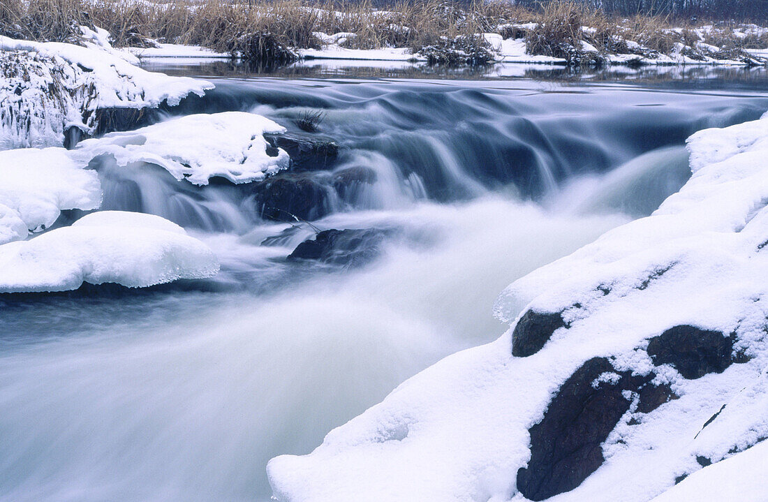 Rapids on Junction creek with fresh snow on shoreline. Walden. Ontario. Canada