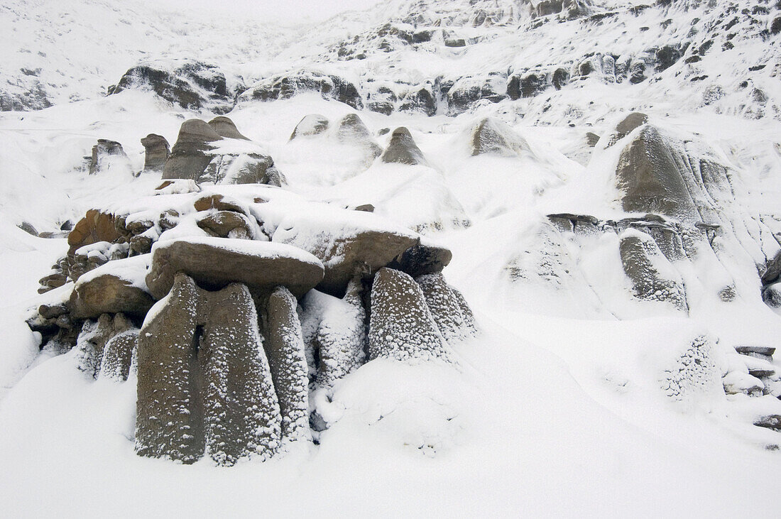 Fresh snow on badlands and Hoodoos formations. Drumheller, East Coulee, Alberta, Canada 