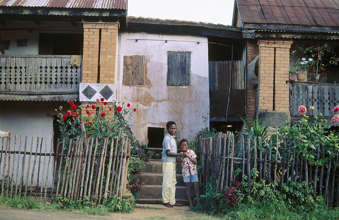 Village homes showing vestiges of French colonial architecture with shutters, brickwork and balconies. Republic of Madagascar.
