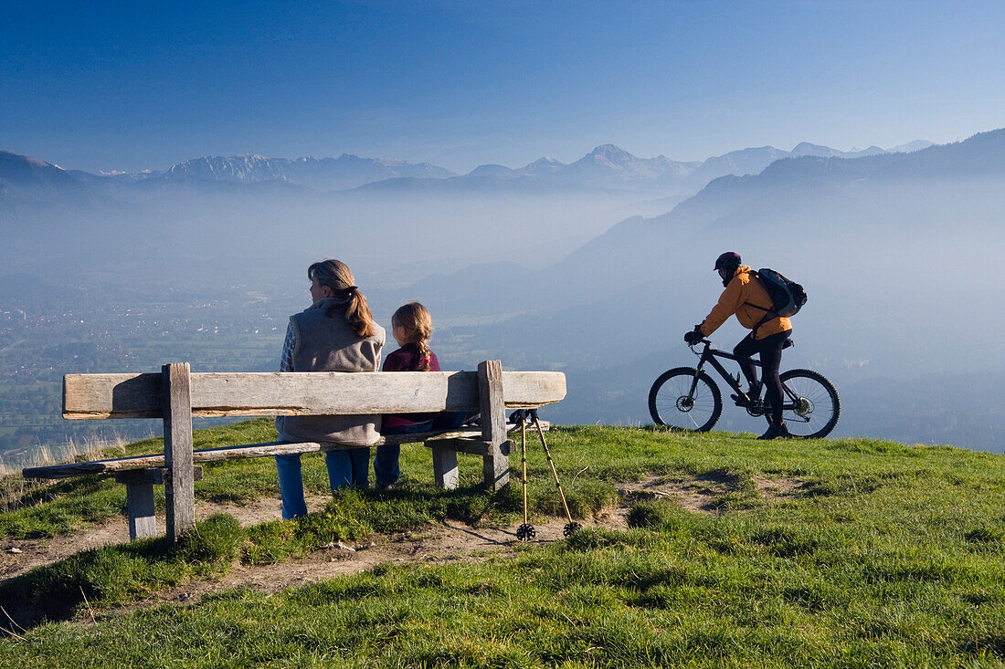 Hikers and mountain biker on mount Heigelkopf, Bad Tolz, Upper Bavaria, Bavaria, Germany