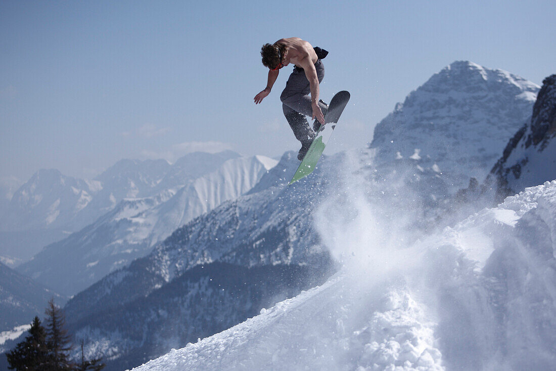 Snowboarder jumping, Reutte, Tyrol, Austria