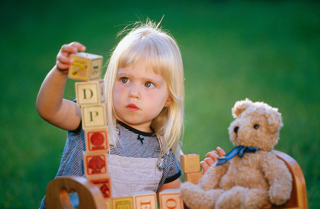 Little girl stacking up blocks