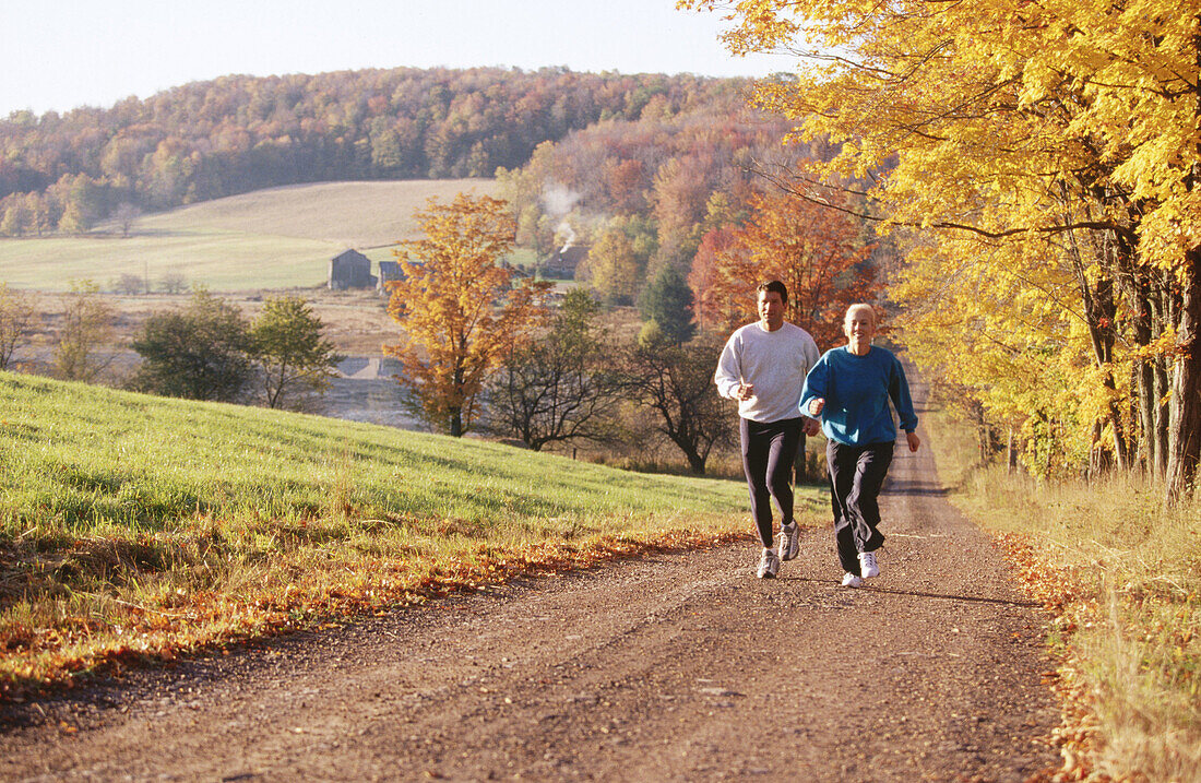 Jogging on country road in autumn