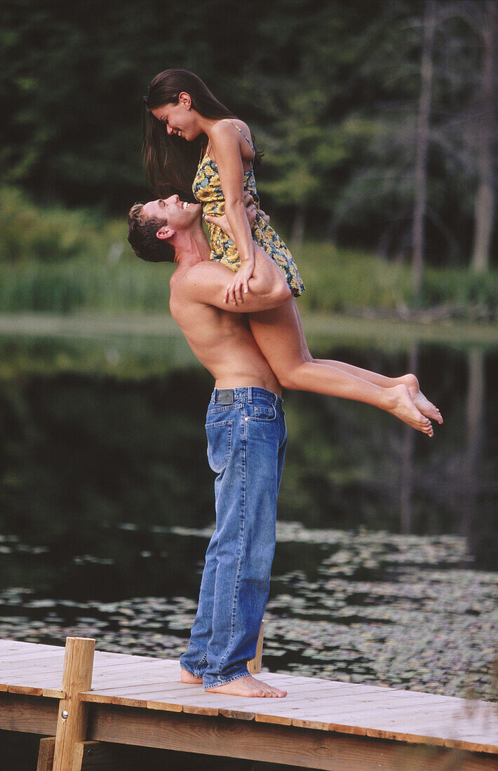 Healthy man lifts his girlfriend