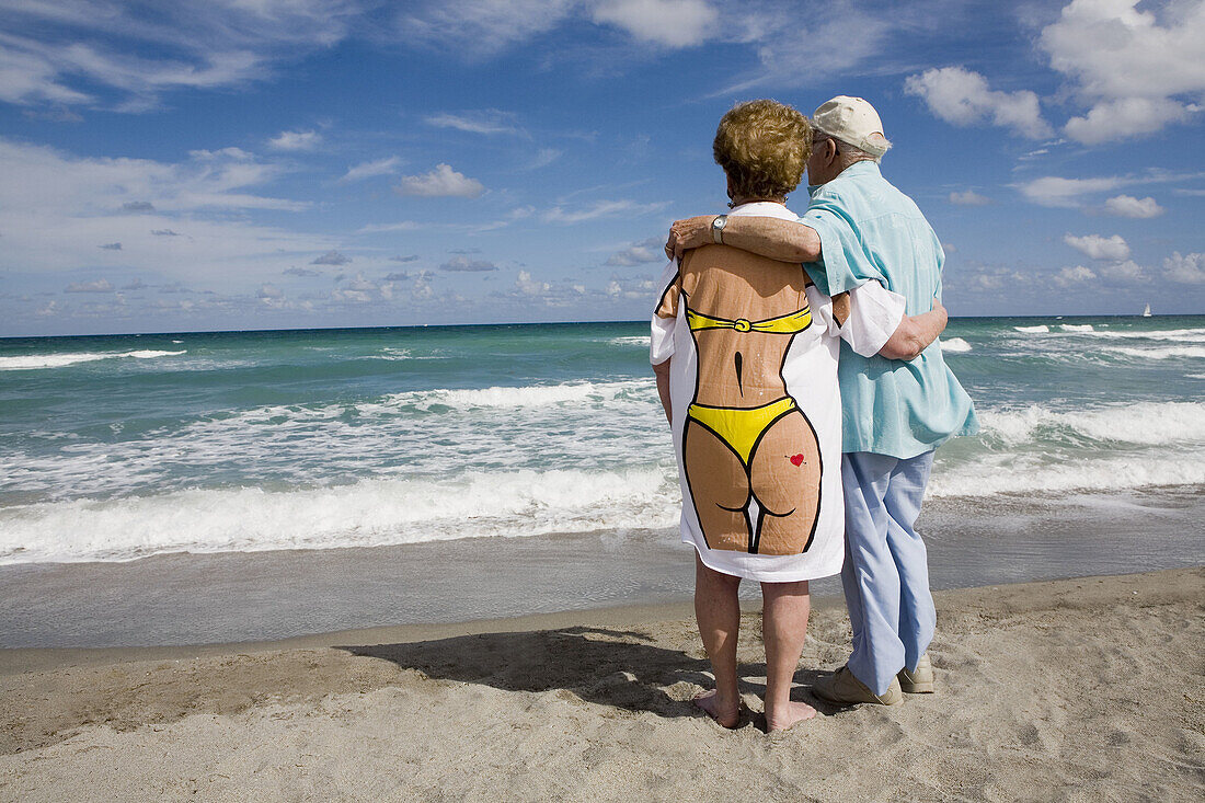 Senior couple hugging, wife wearing humorous tee shirt