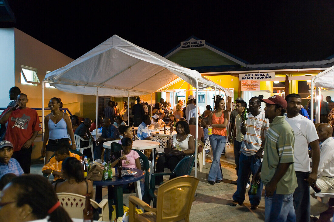 People visiting Friday Market at night, Oistins, Barbados, Caribbean