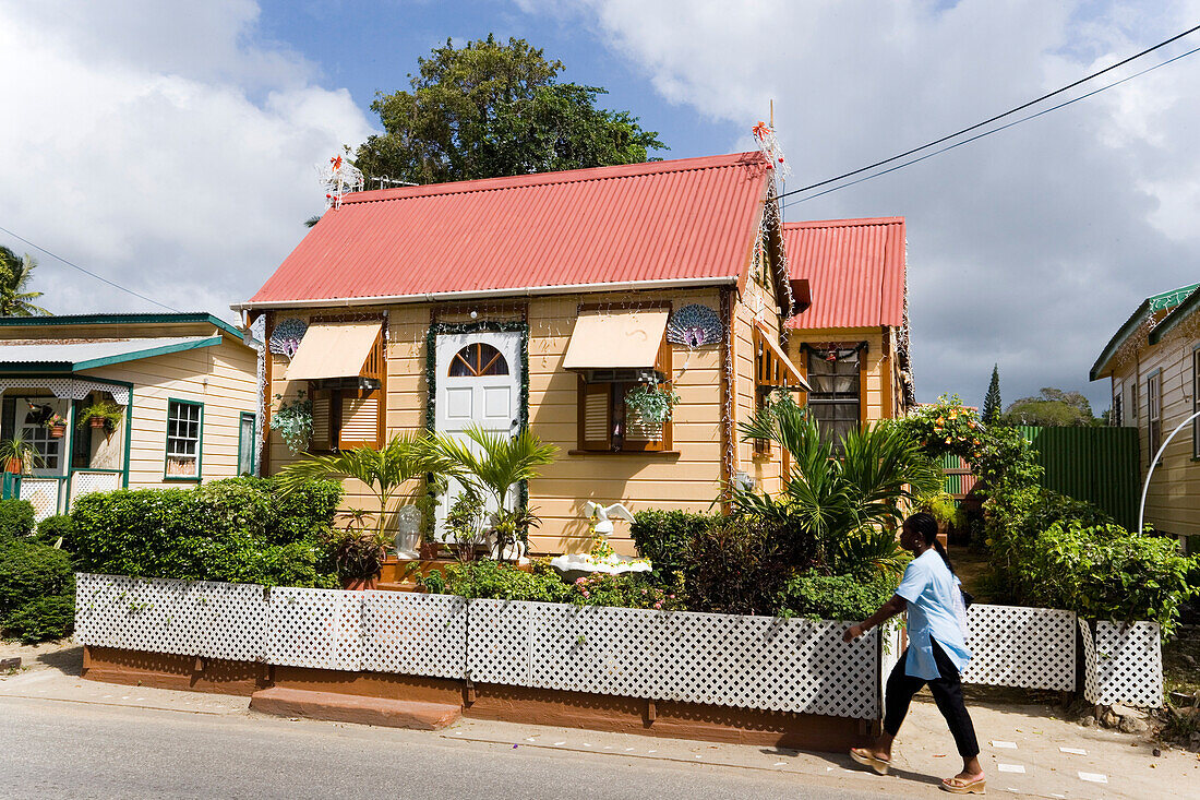 Person passing Chattel House, West Coast, Barbados, Caribbean