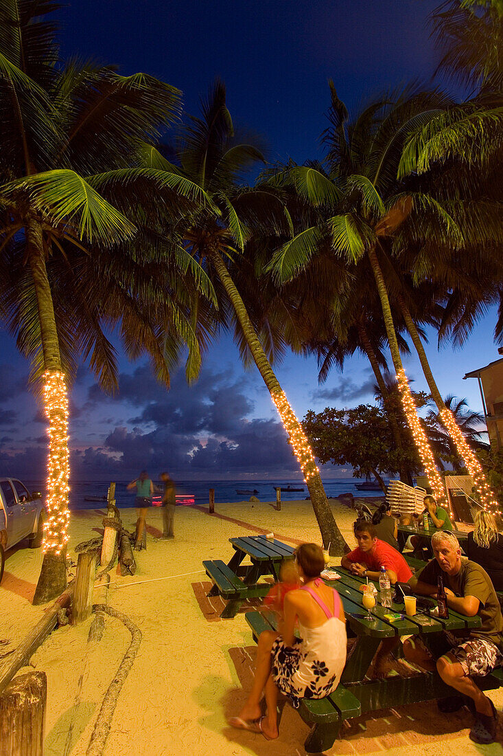 Guests in the Carib Beach Bar in the evening, Barbados, Caribbean