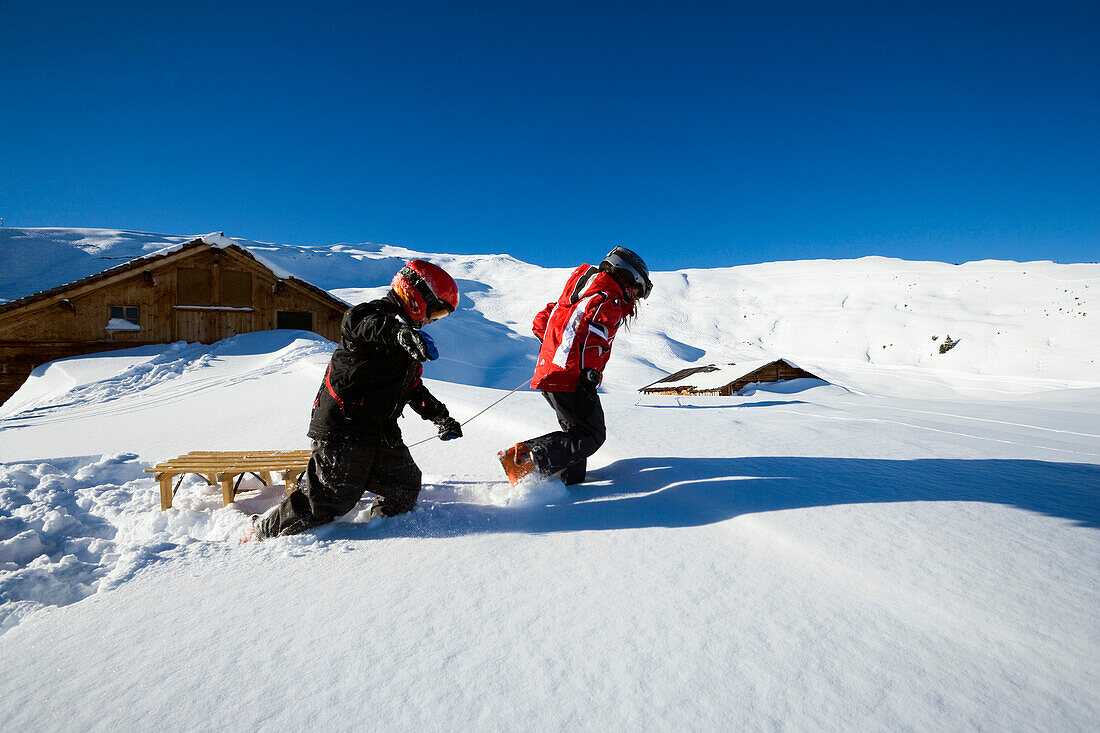 Children with a sledge near alpine hut, Maennlichen, Grindelwald, Bernese Oberland, Canton of Bern, Switzerland