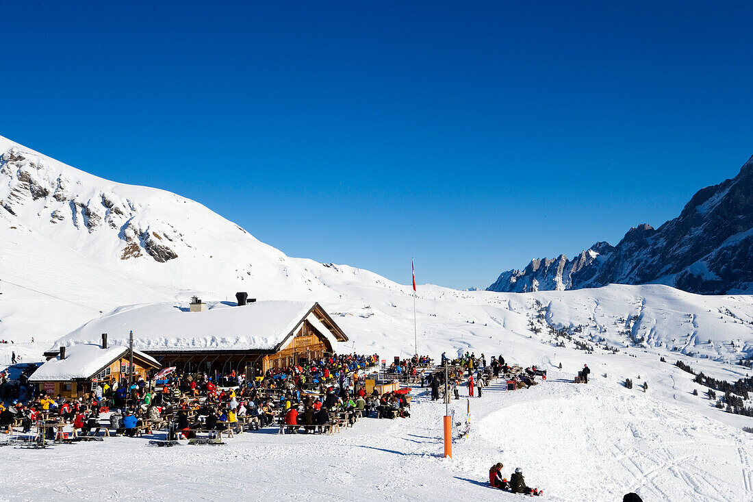 Skiers resting at mountain restaurant Schreckfeld, First, Grindelwald, Bernese Oberland, Canton of Bern, Switzerland