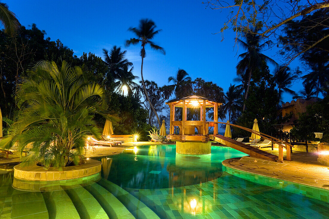 Illuminated pool area in the evening, The Sands, at Nomad, Diani Beach, Kenya