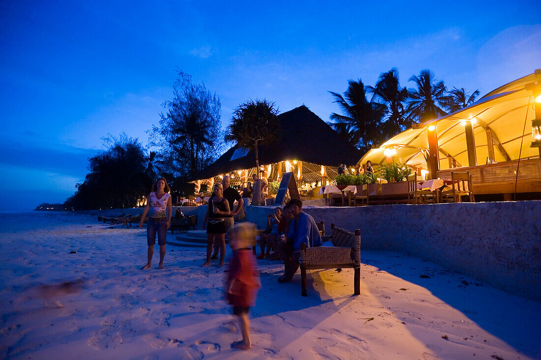 Guests attending a beach party in a beach restaurant, The Sands, at Nomad, Diani Beach, Kenya
