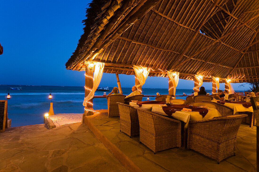 Couple sitting in a beach bar, The Sands, at Nomad, Diani Beach, Kenya
