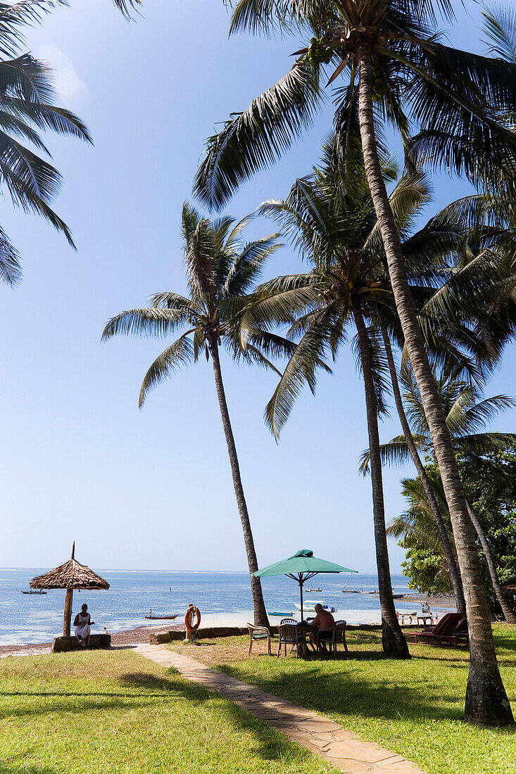 People relaxing at beach of the Sarova Whitesands Beach Resort ans Spa Hotel, Shanzu Beach, Coast, Kenya