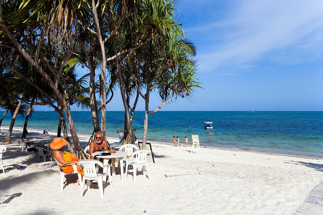 Couple sitting in a beach bar at Shanzu Beach, Dolphin Hotel, Coast, Kenya