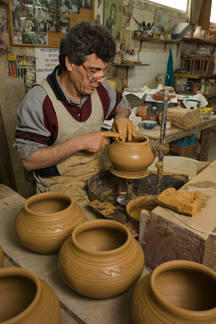 Craftsman in his workshop at the potters wheel, making ceramic pottery from clay, Emira pottery, Larnaka, South Cyprus, Cyprus