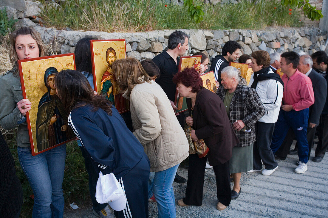 People holding icons at a procession, People kissing icons, Orthodox icon procession, Agros, Troodos mountains, South Cyprus, Cyprus