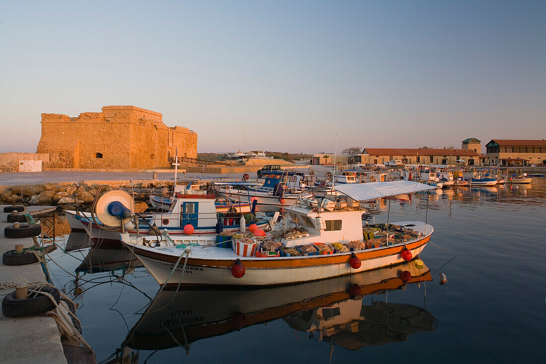 Paphos Castle with fishing boats, Reflection in the water, Paphos harbour, Paphos, South Cyprus, Cyprus