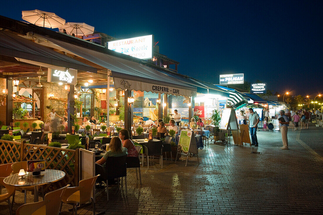 Restaurant, cafe along the harbour promenade at night, Paphos, South Cyprus, Cyprus