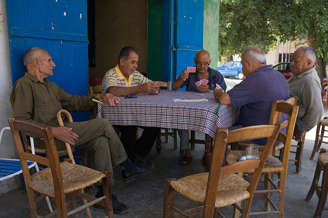 Einheimischer Männer beim Kartenspielen vor einem Café, Kafenion, Kato Pyrgos, Südzypern, Zypern