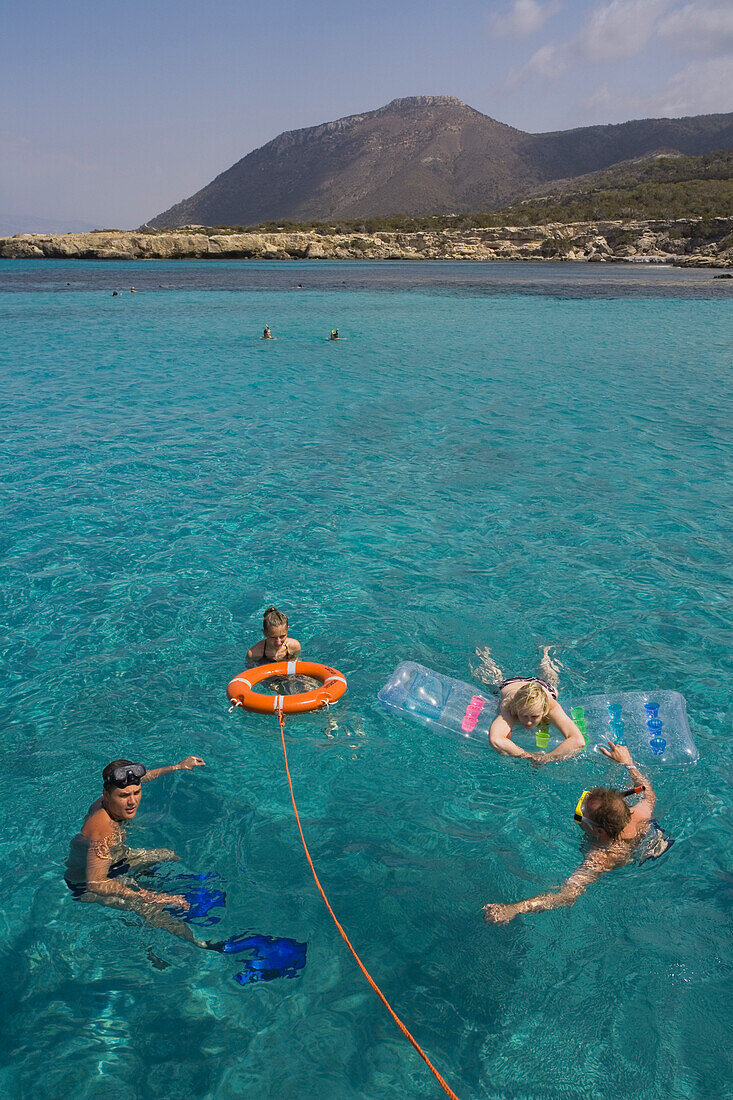 A group of people swimming in the sea during trip in a glass bottom boat with Spyros Plakides, Akamas coast, from Latsi harbour, near Polis, Cyprus