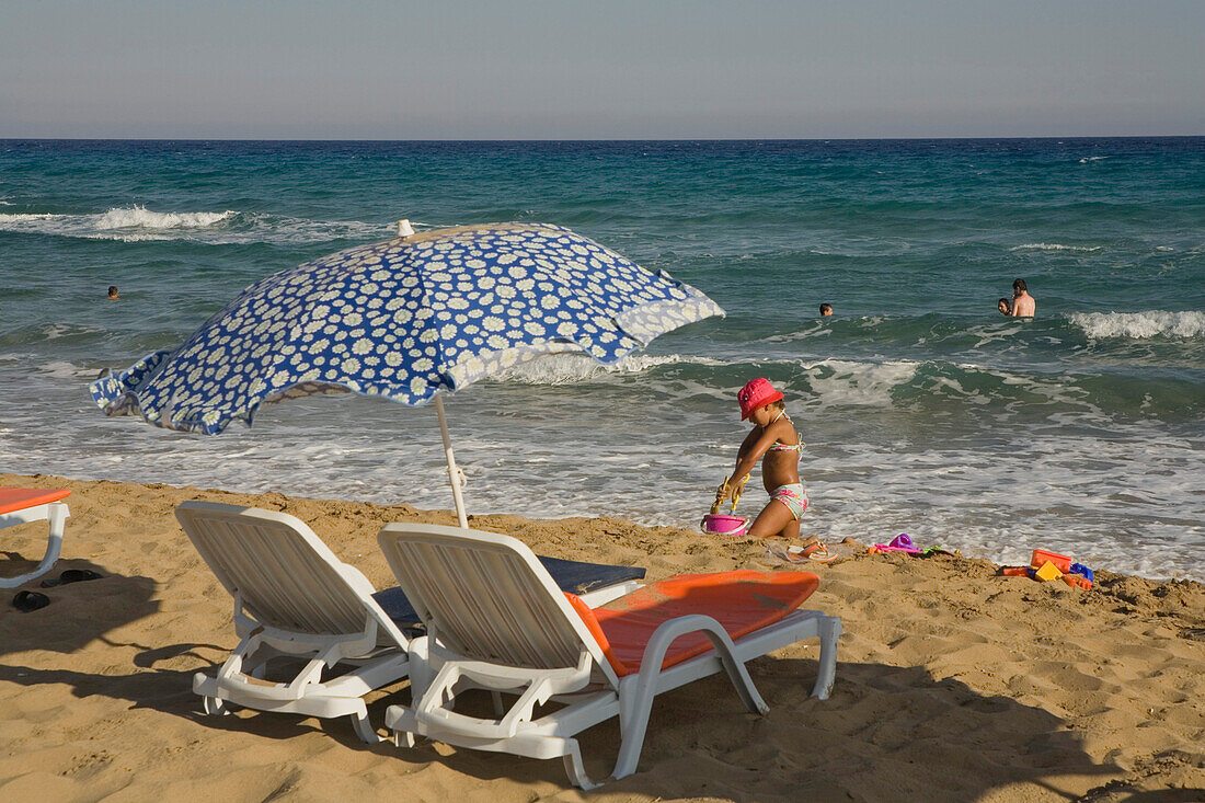 Girl playing on the beach, Golden Sands, Golden Beach, Dipkarpaz, Rizokarpaso, Karpasia, Karpass Peninsula, Cyprus
