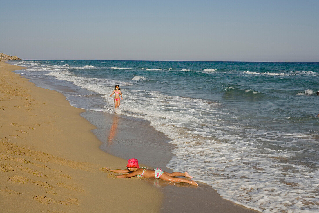 Girl playing on the beach, Golden Sands, Golden Beach, Dipkarpaz, Rizokarpaso, Karpasia, Karpass Peninsula, Cyprus