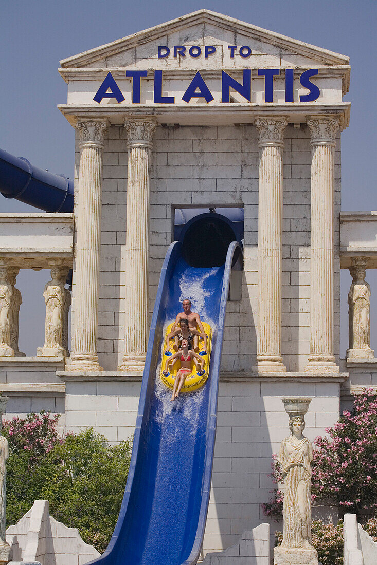 Three young people on a water slide, WaterWorld Waterpark, Agia Napa, South Cyprus, Cyprus