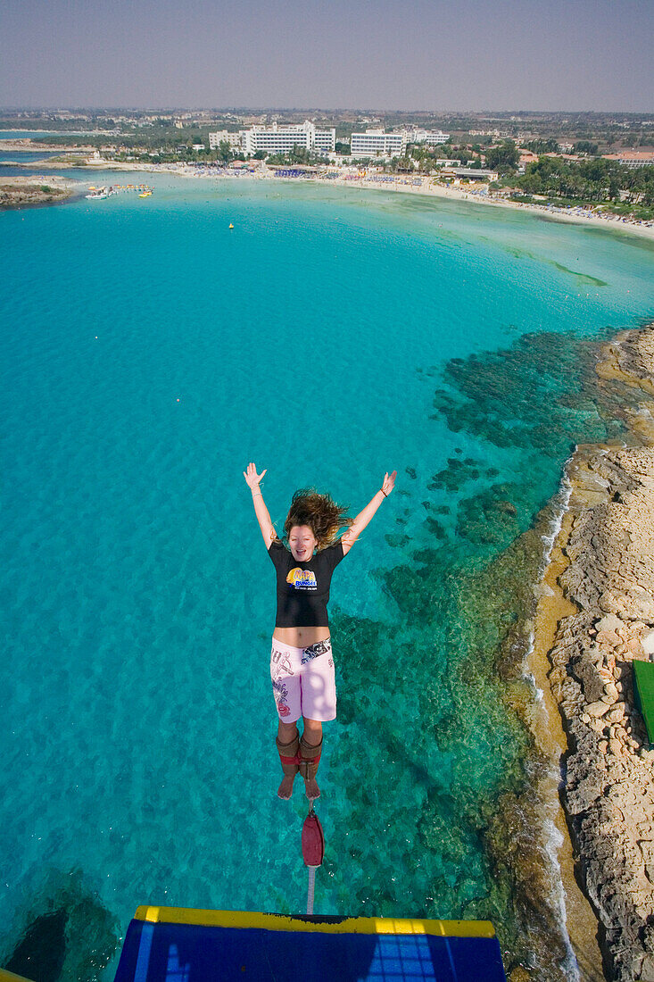 A young woman bungee jumping near Nissi Beach, Napa Bungee, Agia Napa, South Cyprus, Cyprus