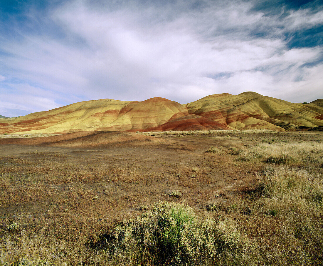 Painted Hills under cloudy sky, John Day Fossil Beds National Monument. Oregon. USA