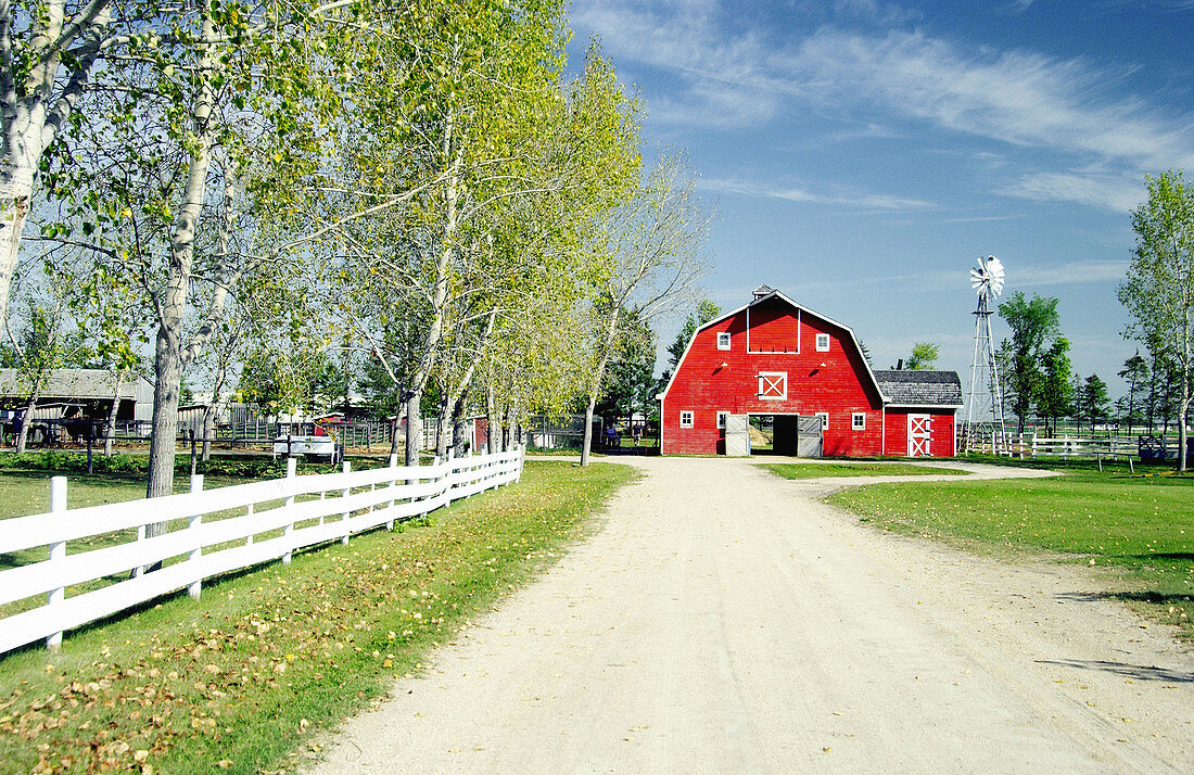A red barn and windmill at the Mennonite Heritage Village in Steinbach. Manitoba, Canada
