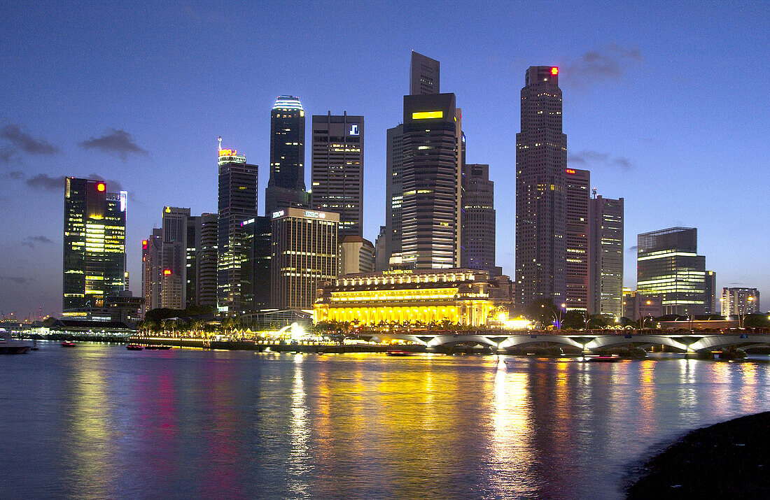 The Singapore skyline and Singapore River at dusk.