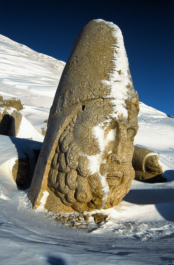 Colossal head of Herakles, remains of the tomb-sanctuary of King Antiochus Theos in the West terrace of Nemrut Dag (Mount Nemrut, 2150 m) part of the former Commagene kingdom. Anatolia, Turkey