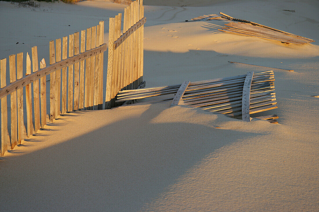 Wooden barriers supposed to hinder the sand from invading the promenade. Cádiz province. Andalusia. Spain