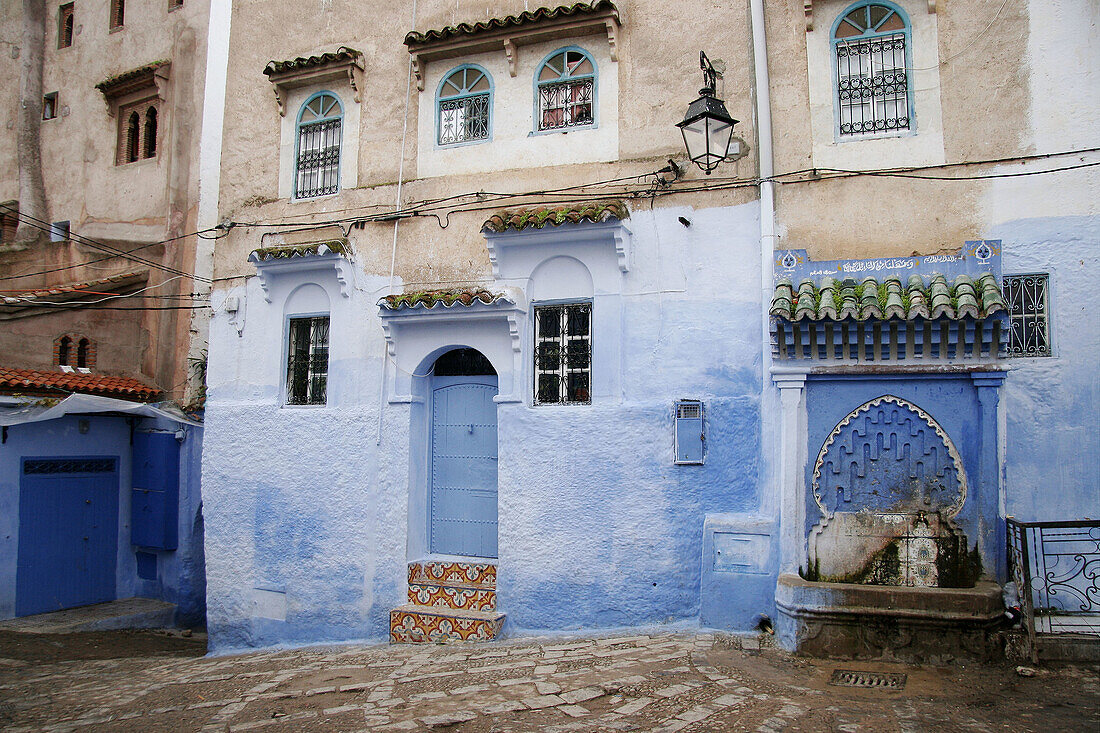 Fountain and houses façades in Chefchaouen. Morocco