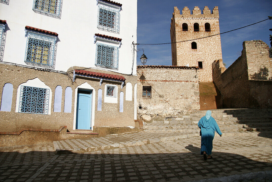 Woman walking on typical street. Chefchaouen. Morocco