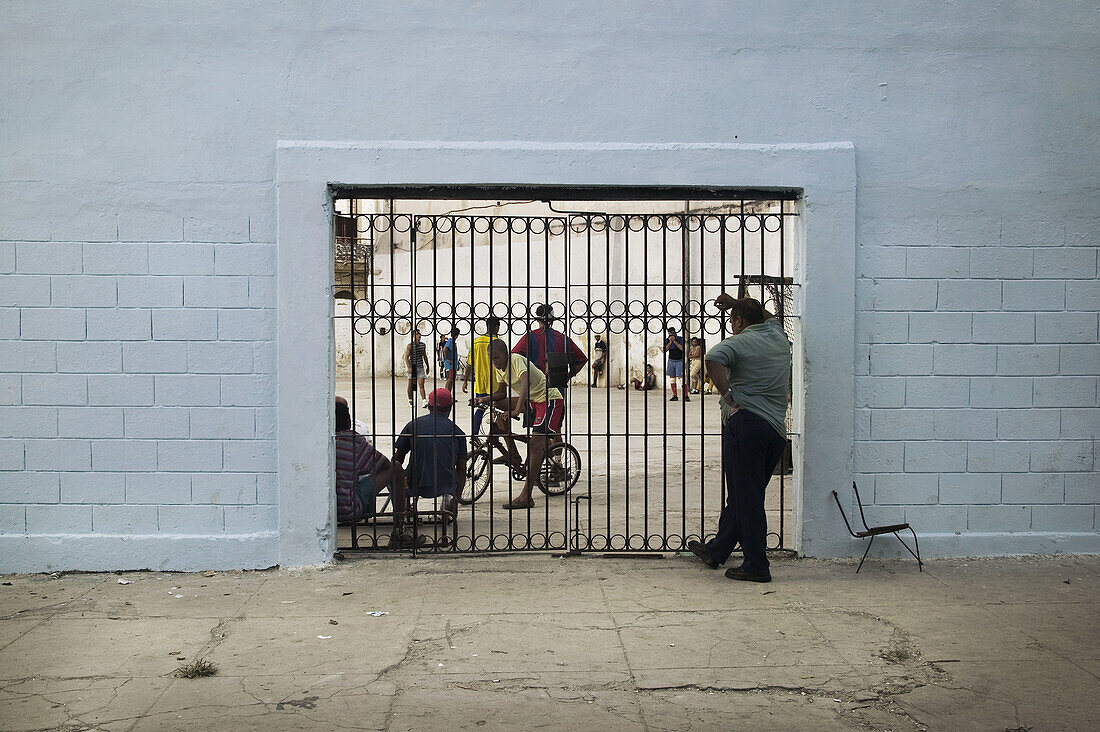 Teens playing soccer in a school yard in Havana, Cuba.