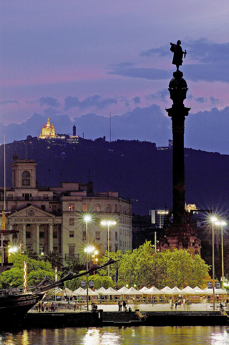 Port of Barcelona at night with statue of Cristopher Columbus and the Sagrat Cor Church. Barcelona. Spain