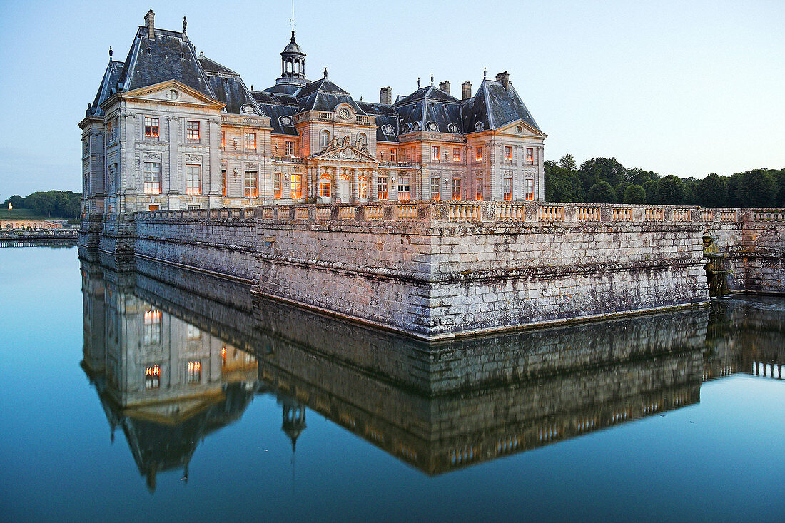 Chateau of Vaux-le-Vicomte illuminated at dusk. Ile de France. France