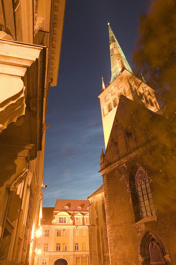 Cobble stone street and St Olaf Church in Old Town at night. Tallinn. Estonia