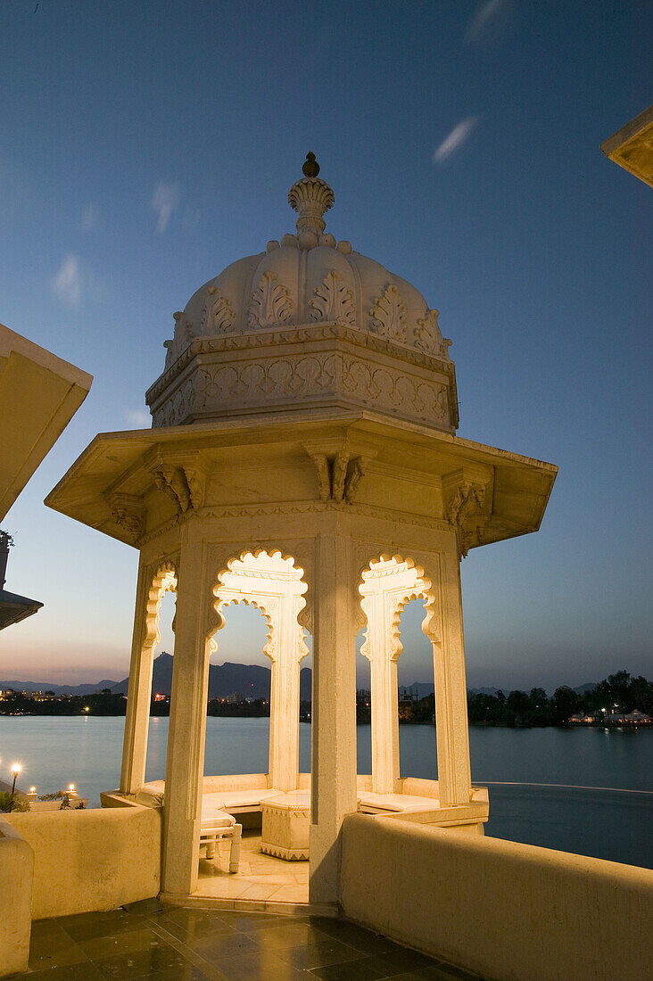 View of the city from the Lake Palace Hotel on Lake Pichola at night. Udaipur. Rajasthan. India