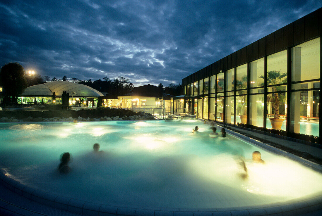 People in the outdoor pool at Alpamare Baths in the evening, Bad Toelz, Bavaria, Germany