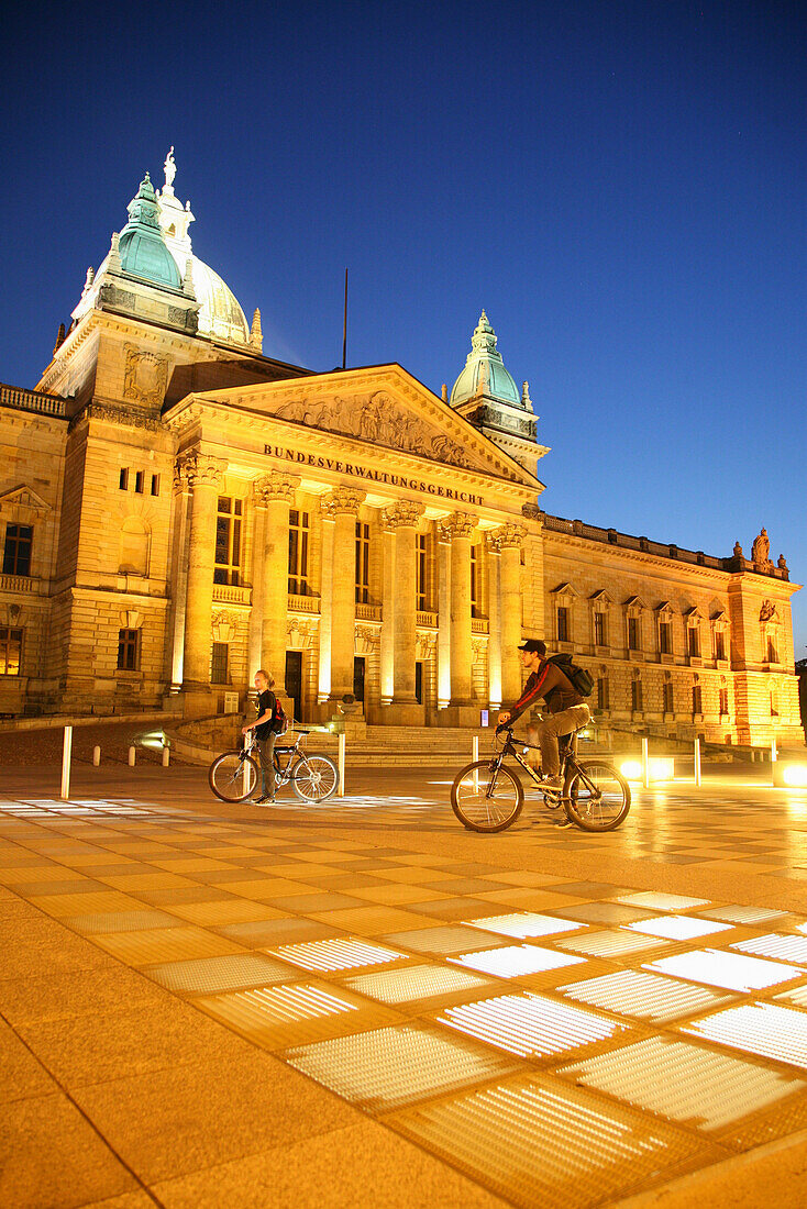 Two cyclists at Federal Administrative Court, Leipzig, Saxony, Germany