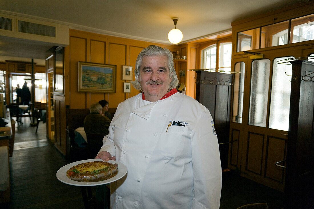 A chef holding traditional food, Restaurant Harmonie, Old City of Berne, Berne, Switzerland