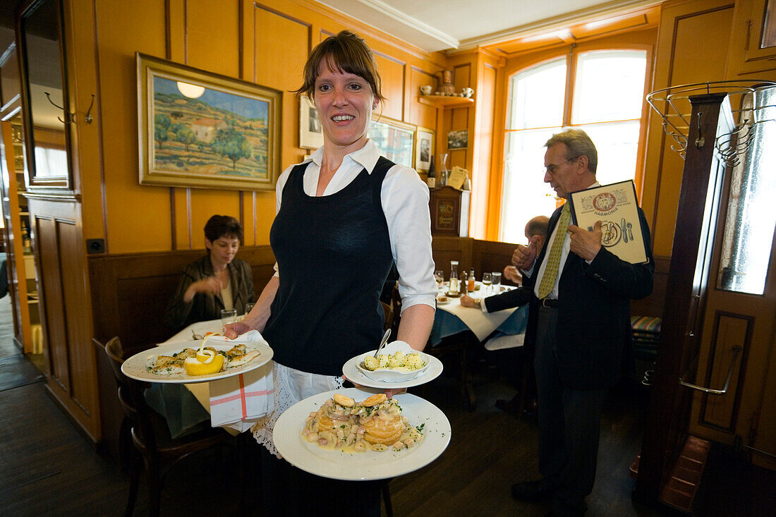 A waitress carrying traditional food, Restaurant Harmonie, Old City of Berne, Berne, Switzerland